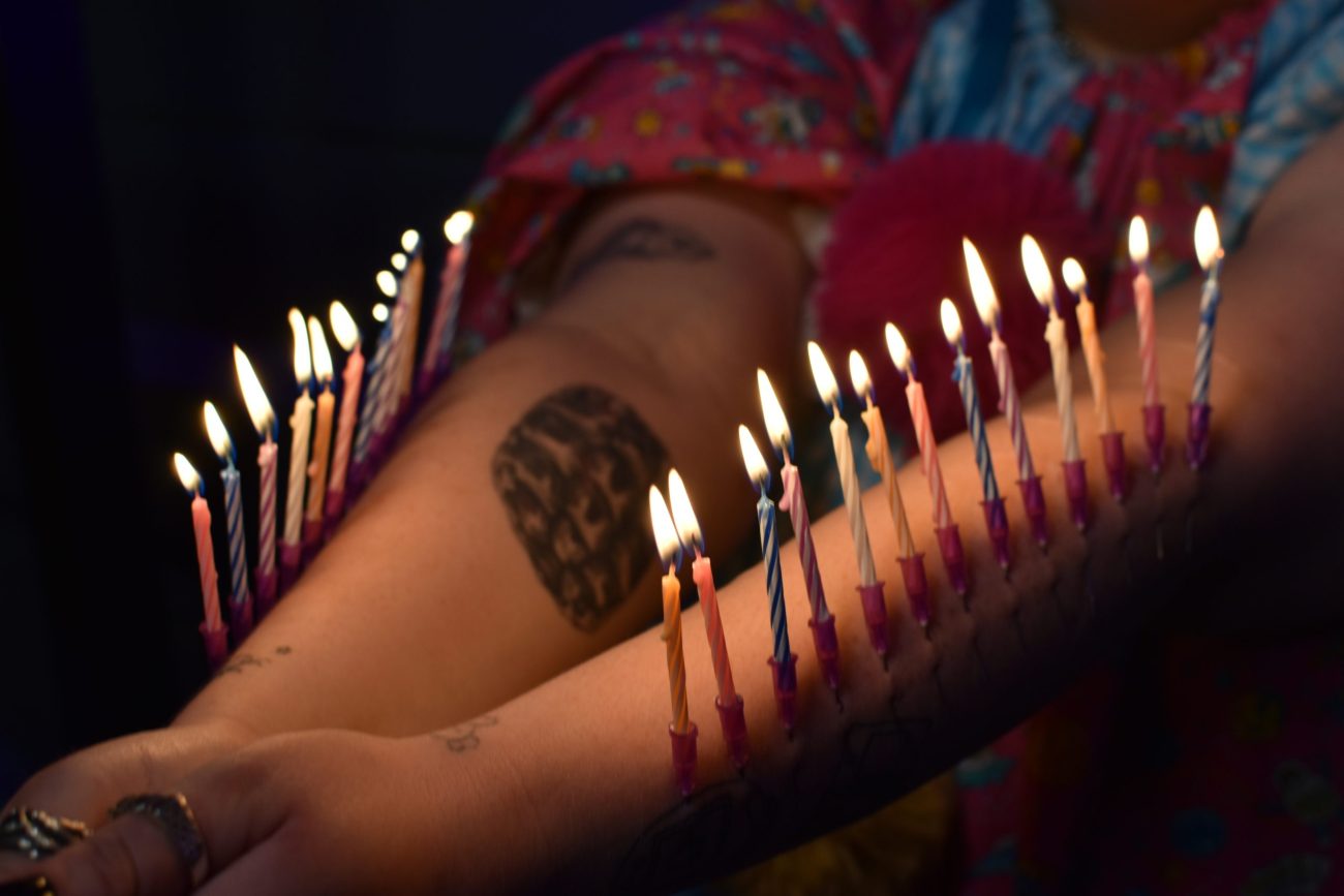 Warning - Birthday candles fixed with needles in arm.
